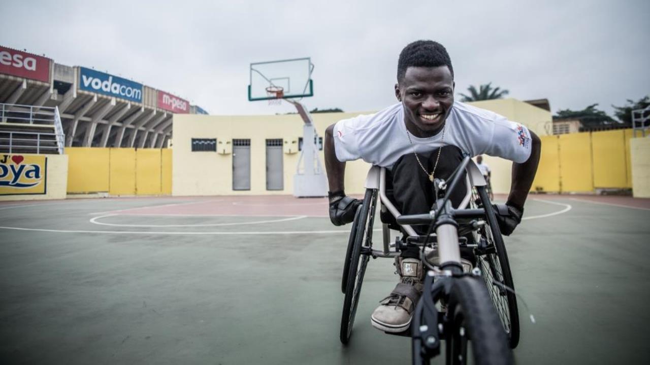 John, an athlete from the DR Congo Paralympic team, warms up before a demonstration of the new racing wheelchairs.; }}