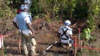Handicap International deminers in action near Kisangani, DRC.; }}