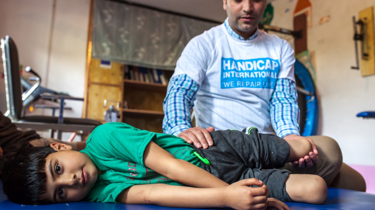 Fayaz during a rehabilitation session with Muddasir Ashraf, a physiotherapist and Disability Manager for Handicap International; }}