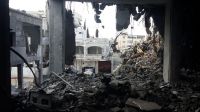 A photo of a building destroyed by air-strikes in teh summer of 2014. Gaza.; }}