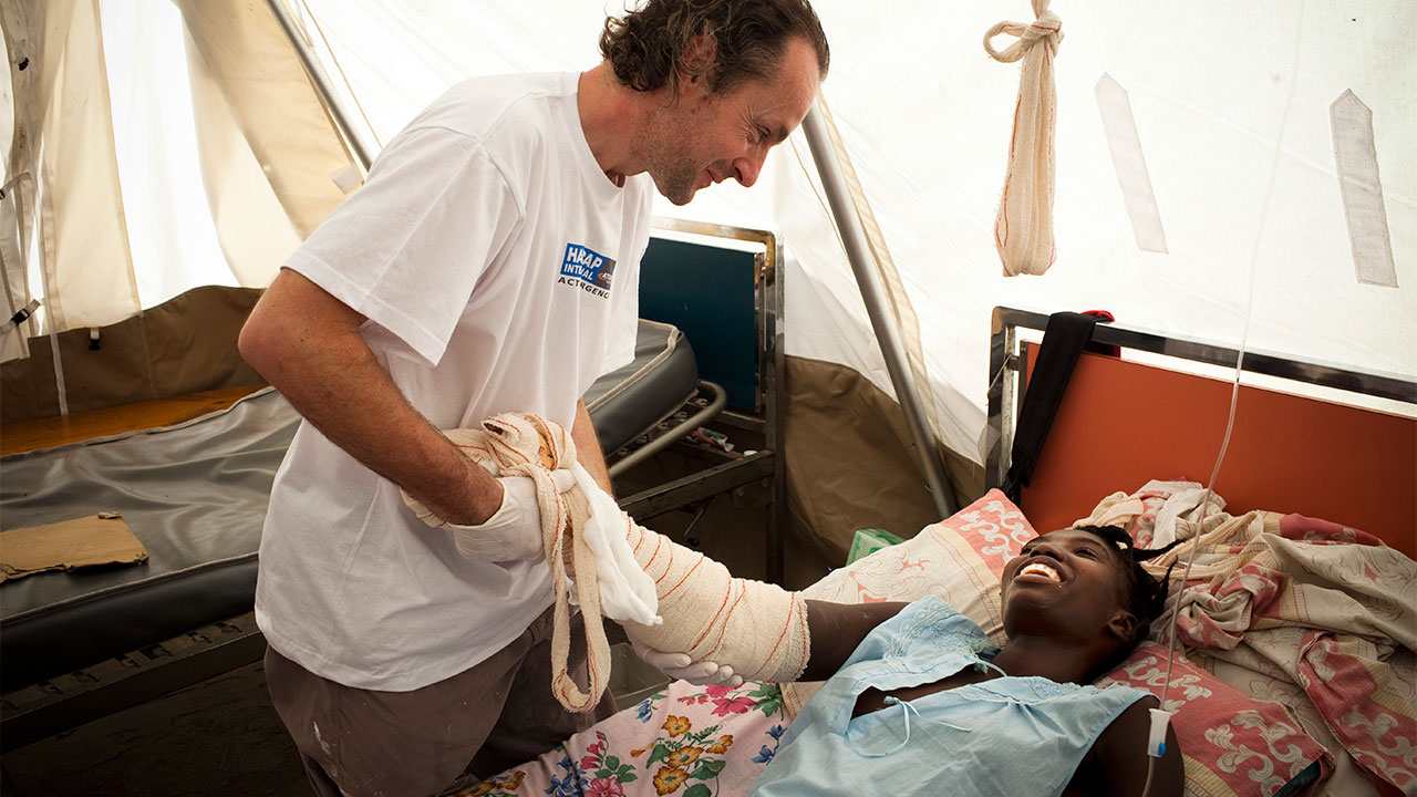 Physiotherapist Olivier Champagne with a patient, Yolande, in an MSF hospital.; }}
