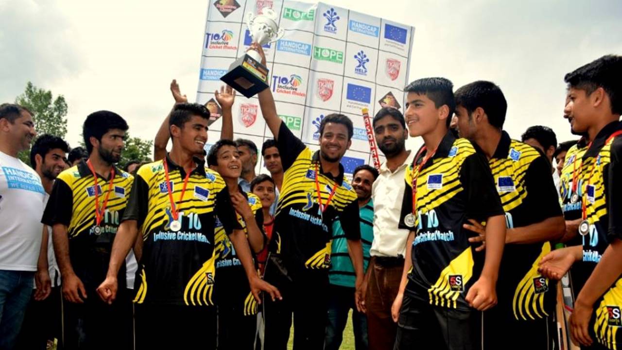 The Kupwara Tigers lift the trophy after an inclusive cricket match organised by Handicap International; }}