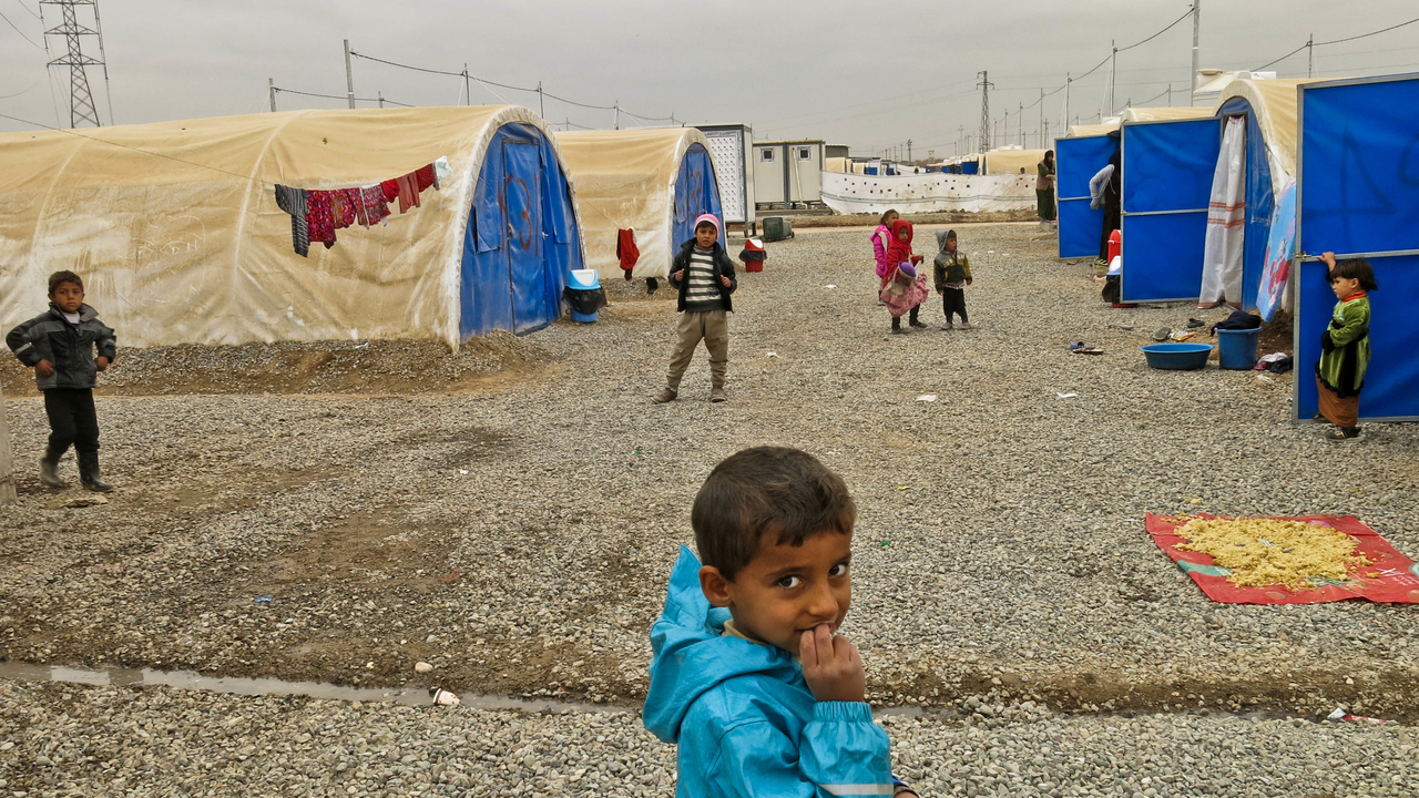 Children playing in Khazer camp, one of the biggest camps hosting displaced persons from Mosul and the region.; }}
