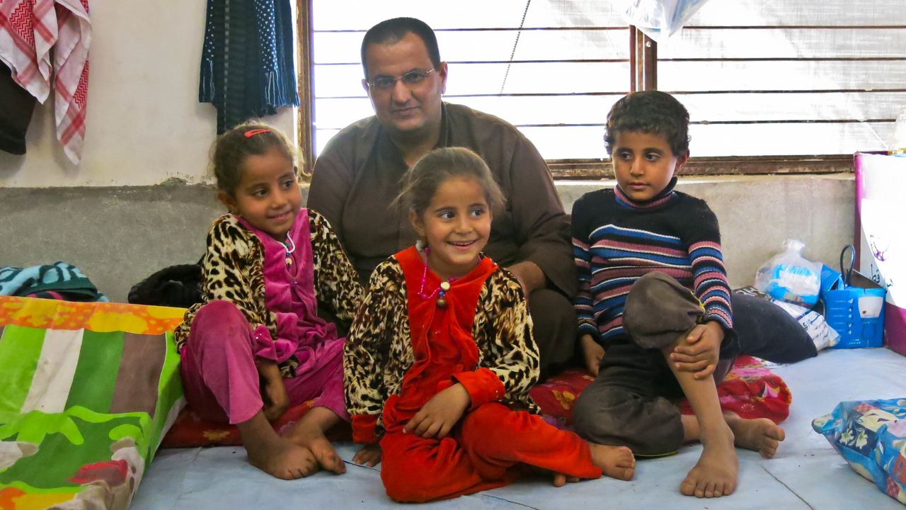  Gaylan and his children in their temporary shelter in Hasansham camp.; }}
