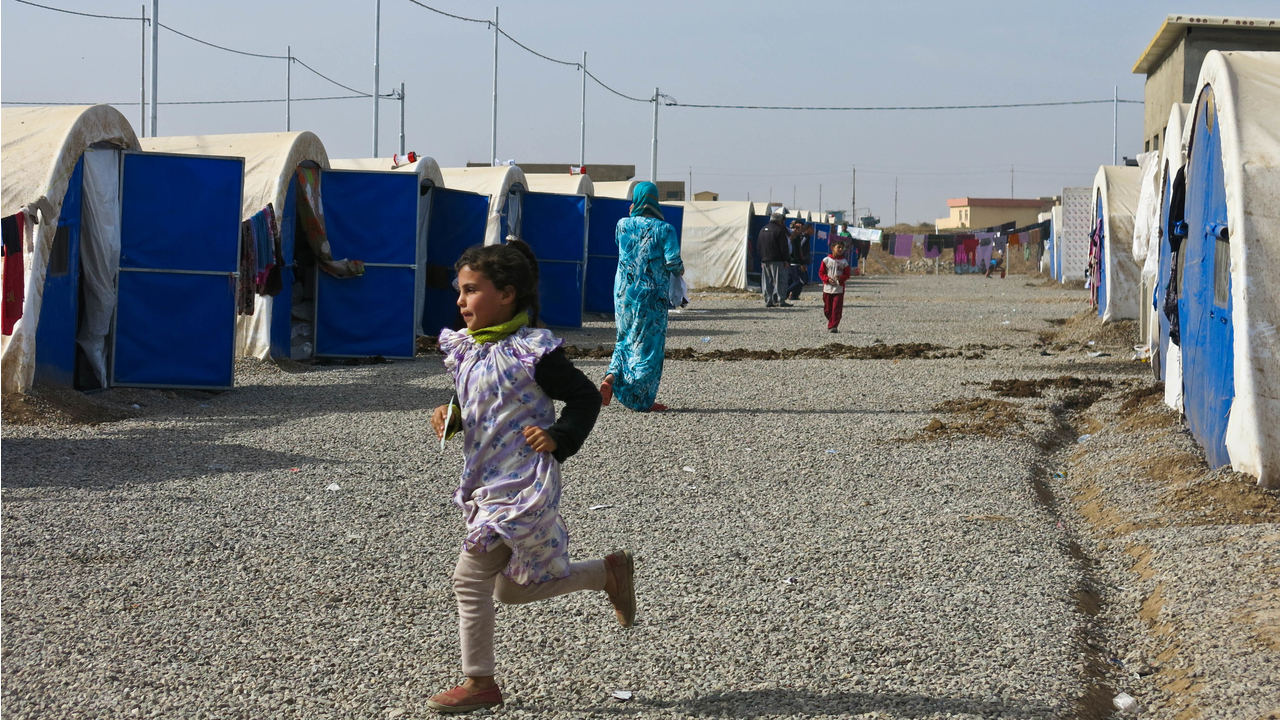 A girl from a displaced family plays in Khazer camp.  ; }}