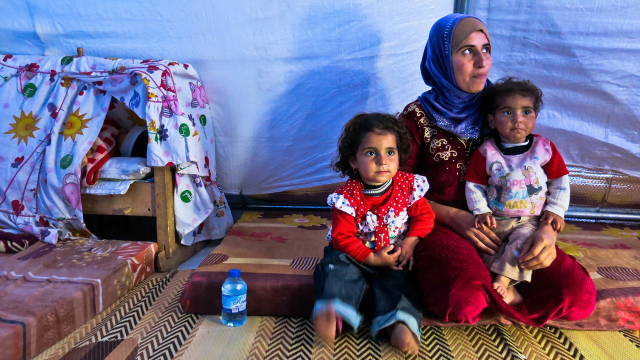 A woman and her children in their tent in Khazer camp, where tens of thousands of IDPs have been living since the 17th October.; }}