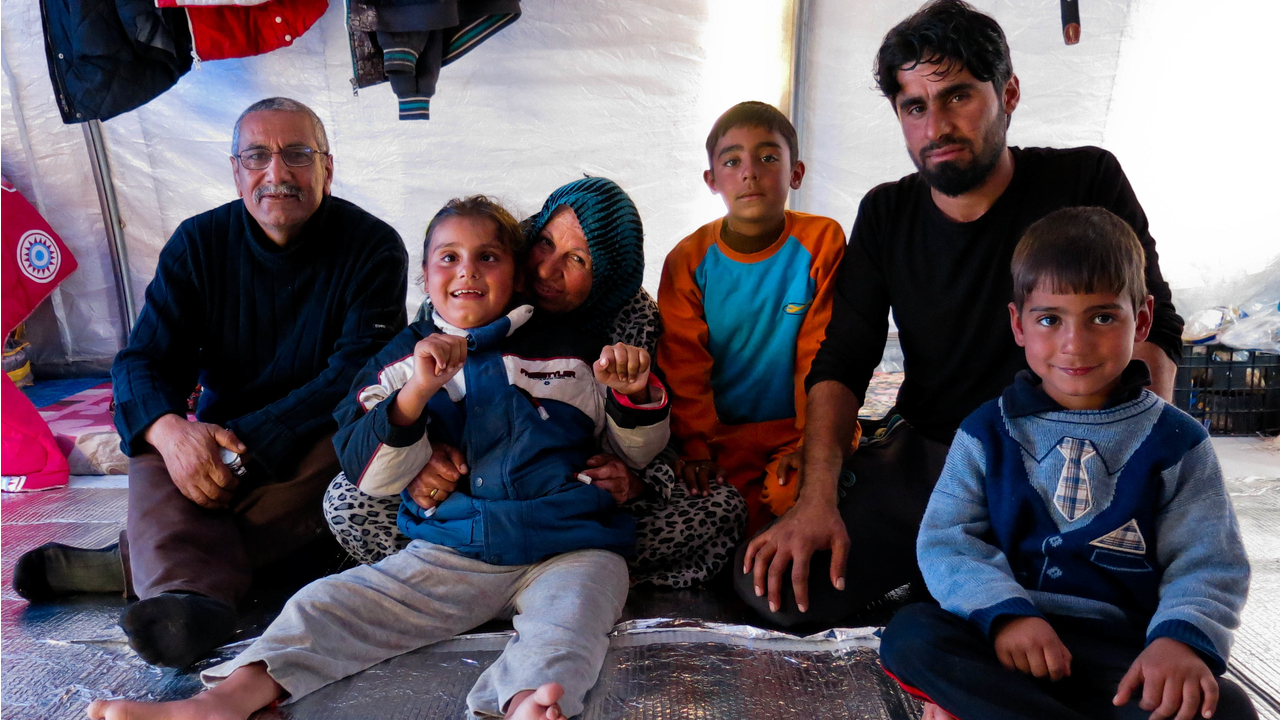 Tiba, her grandparents, father and brothers in their tent.; }}
