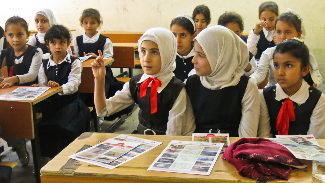  Girls take part in a mine risk education session at a school in the governorate of Kirkuk, Iraq.; }}