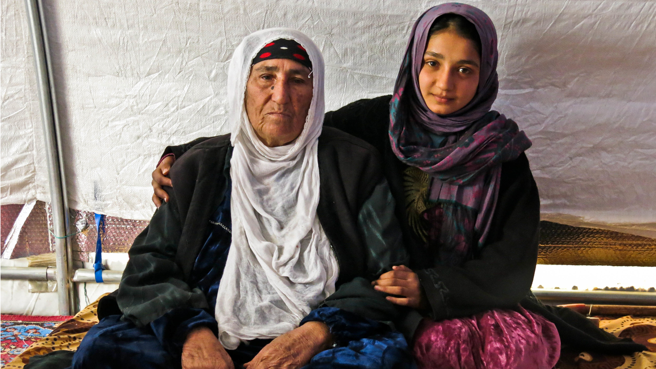 Reema with her granddaughter Dhoha in their tent in  Khazer camp. ; }}