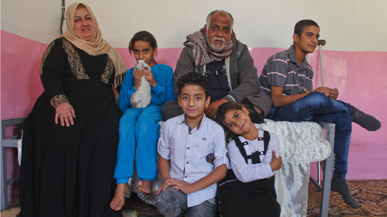  Sabah and his family in one of their two rooms.; }}