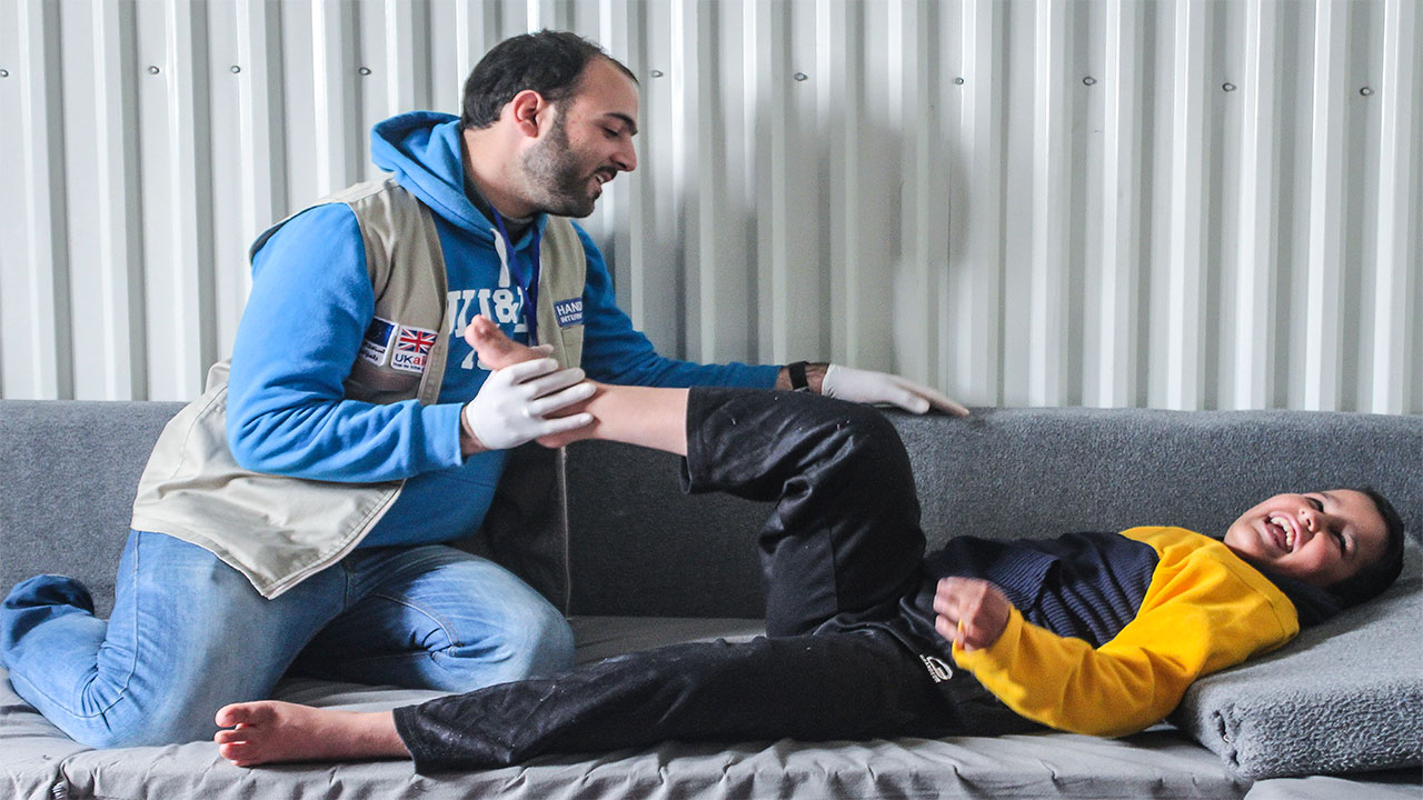 13-year-old refugee Abdel Rahman, who has muscular dystrophy, takes part in a physiotherapy session, Jordan.; }}