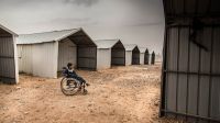 A disabled Syrian child sitting in a wheelchair in Azraq camp, Jordan.; }}