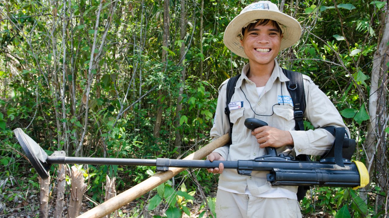 Nouay shows the tools he uses to clear UXO. ; }}