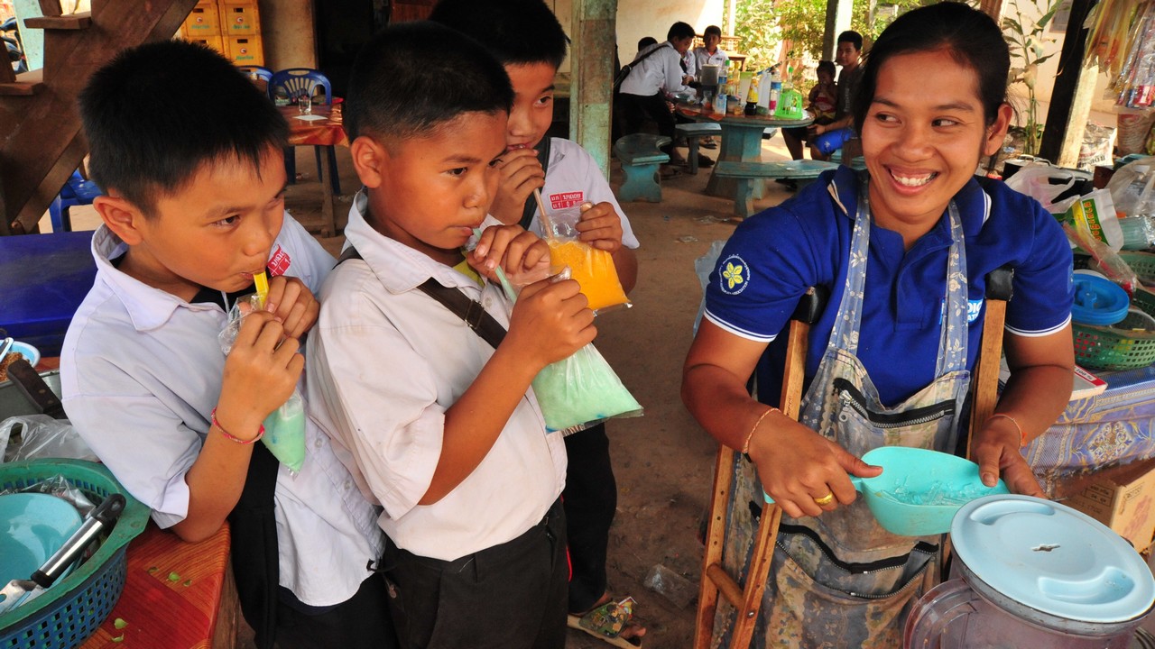 Bouachanh Douangharath, 27, has a stall selling snacks in Nakhoui village, Laos.; }}