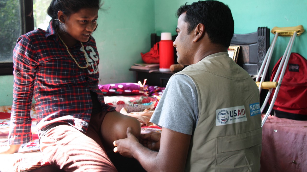Earthquake survivor, Priya, 14, during a rehabilitation session with a Handicap International physiotherapist.; }}