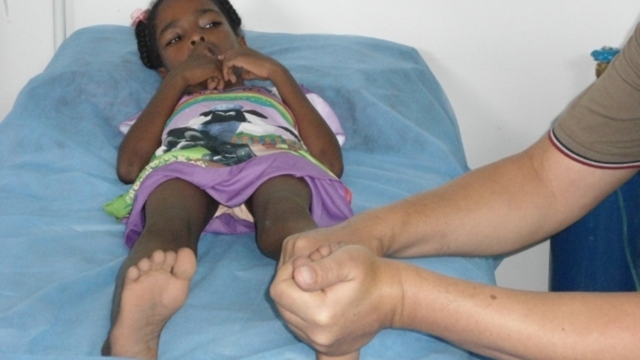 A child receiving care from Handicap International's mobile team; }}