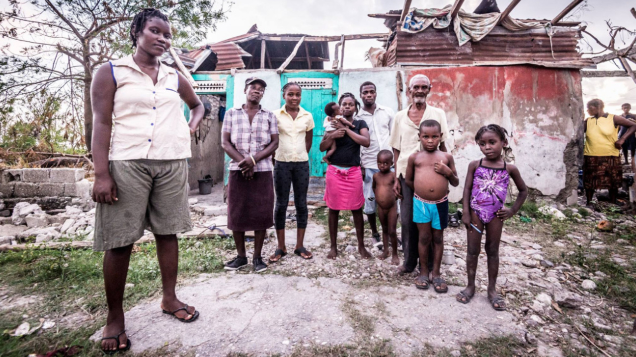Inès Virgile outside her home destroyed by the hurricane. ; }}