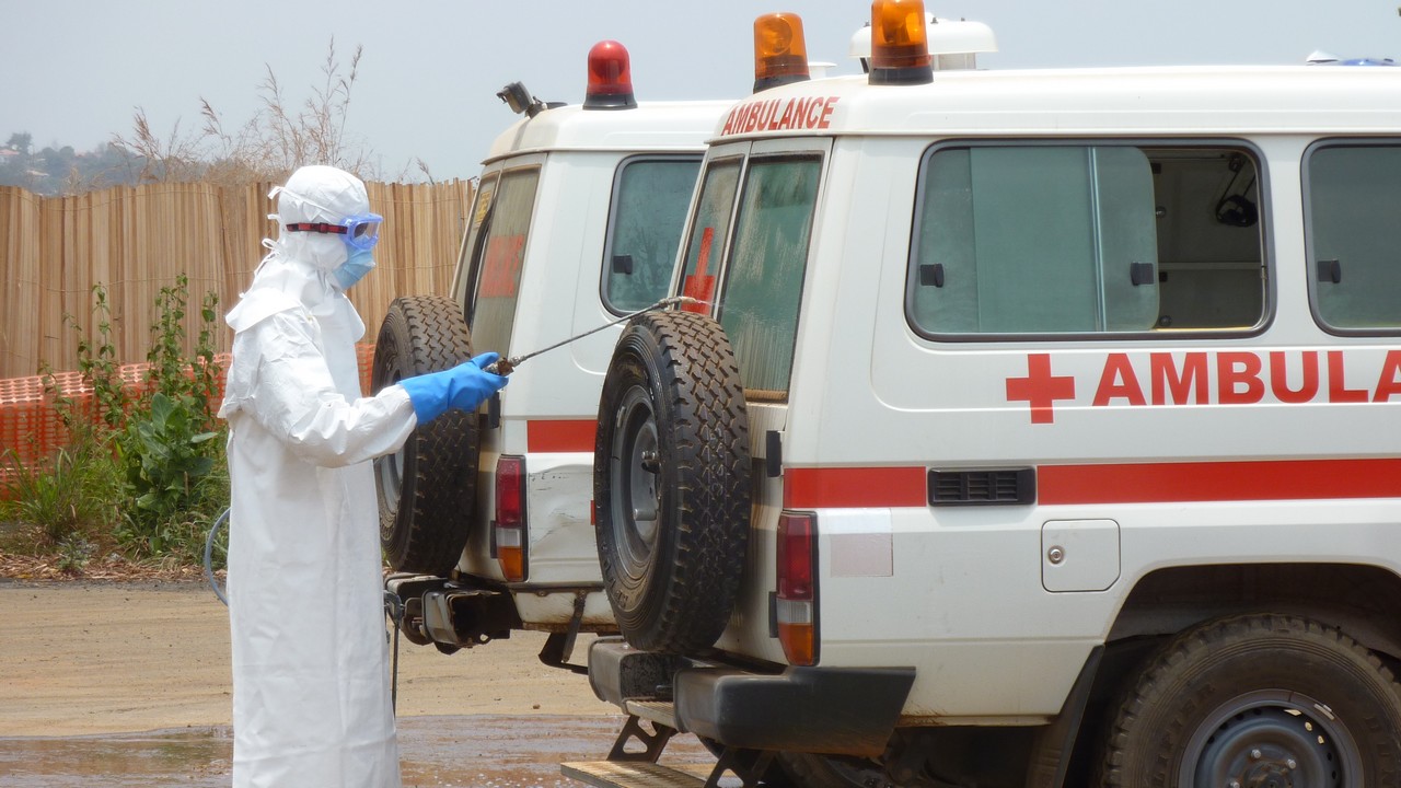 A member of Handicap International's ambulance service team cleans an ambulance with a chlorine solution. Sierra Leone.; }}