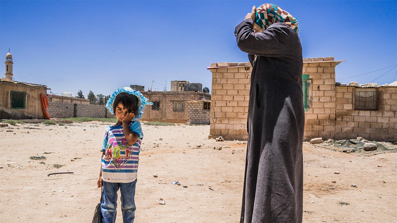 Mother and daughter of a displaced Syrian family; }}