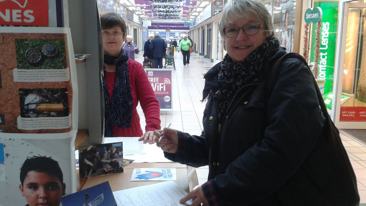 A Christmas shopper in Rugby takes time out to sign the Stop Bombing Civilians petition at a stall organised by Rugby Soroptimists.; }}