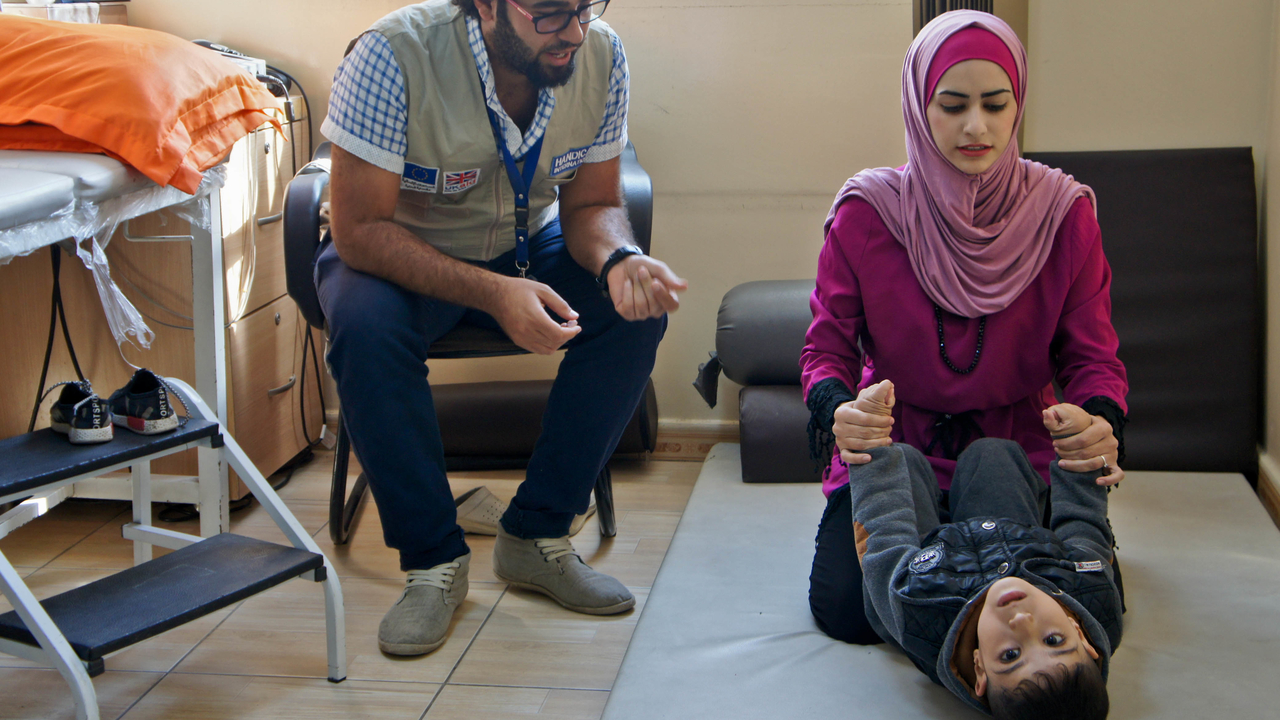  Manal, Hamzeh and Ali, during a physiotherapy session.; }}