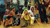  Women in a refugee camp waiting for food aid; }}