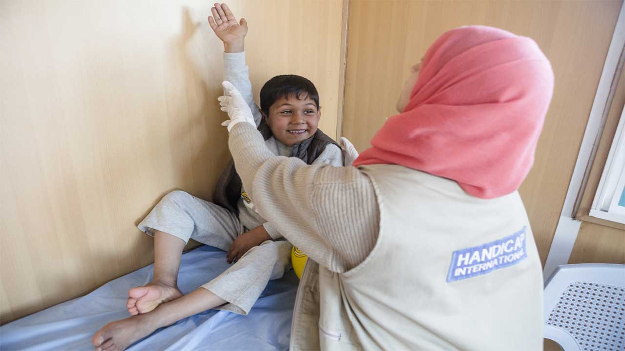 Noor, who has been paralysed in his right arm since he was born, during a rehabilitation session in Azraq refugee camp, Jordan.