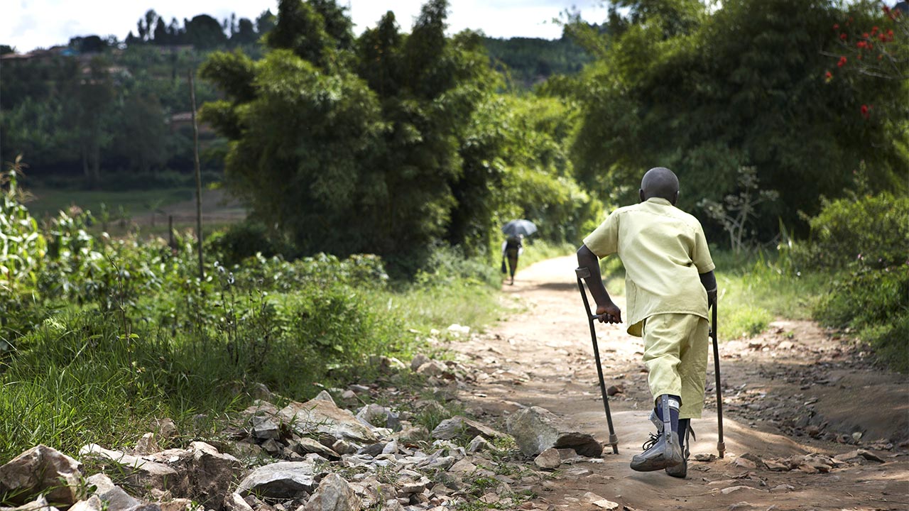 Claude, 15, walking home from school, Muhanga District, Rwanda.