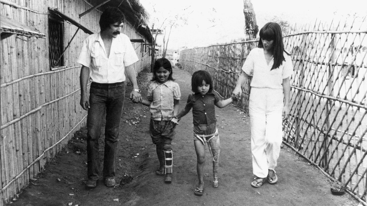 Jean Baptiste and Marie Richardier with 2 disabled children, Mom and Sorpin, in the Khao I Dang refugee camp on the Thai-Cambodia border, 1980s